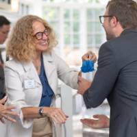 faculty happily handing out bags